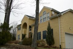 Paper / wire / scratch / brown / with traditional cement stucco finish coat.  Cement stucco quoines.